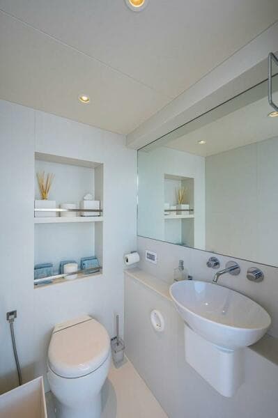 Modern bathroom in 2020 Majesty 140 yacht with sleek fixtures and minimalist design.