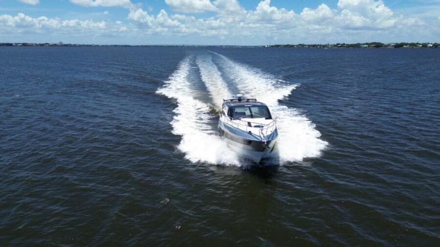 Luxury yacht Real 40 HT 2025 cruising on open water under blue skies.