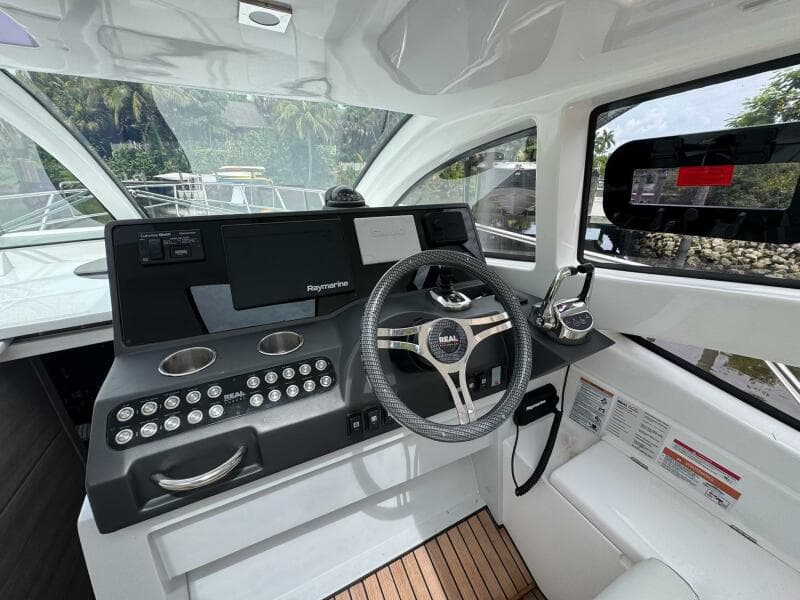2025 Real 40 HT Luxury yacht cockpit with modern steering and navigation controls.
