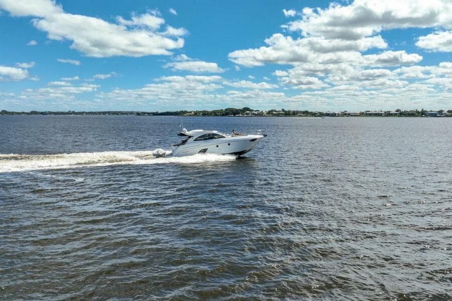 2014 Beneteau Gran Turismo 44 yacht cruising on a sunny day with blue skies.