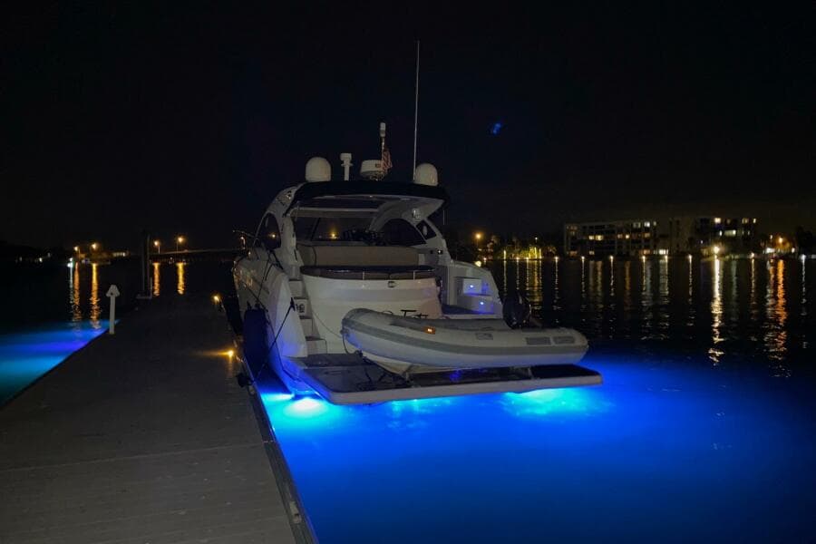 2014 Beneteau Gran Turismo 44 yacht docked at night with blue underwater lights.