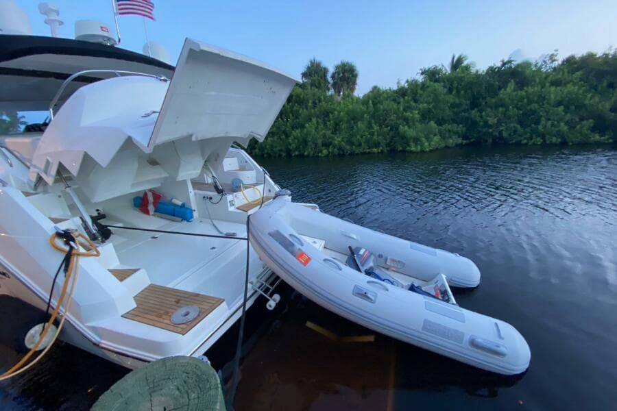 2014 Beneteau Gran Turismo 44 yacht with inflatable boat on calm water.