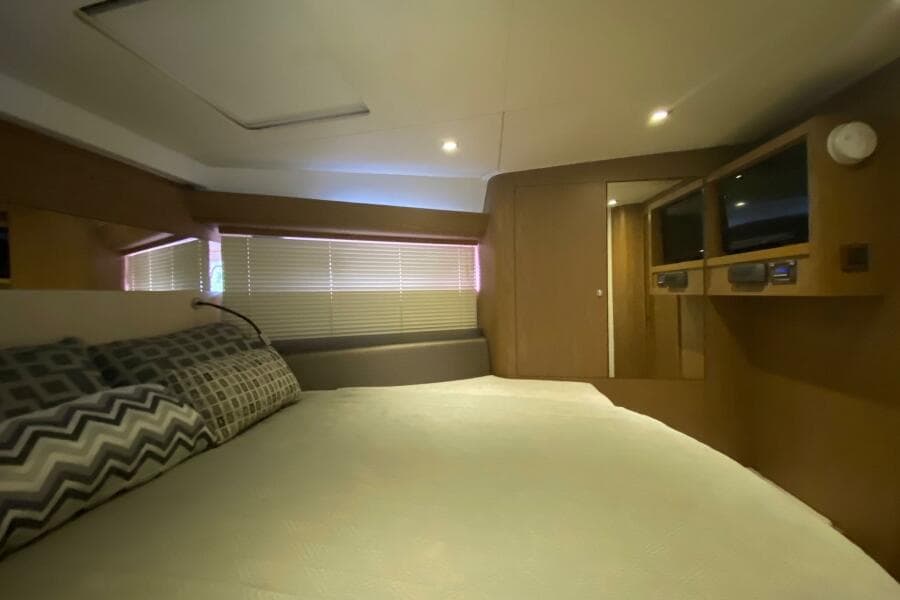 Luxurious cabin interior of 2014 Beneteau Gran Turismo 44 yacht with cozy bedding.