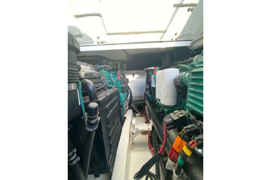 Engine compartment of a 2014 Beneteau Gran Turismo 44 yacht, showcasing mechanical components.