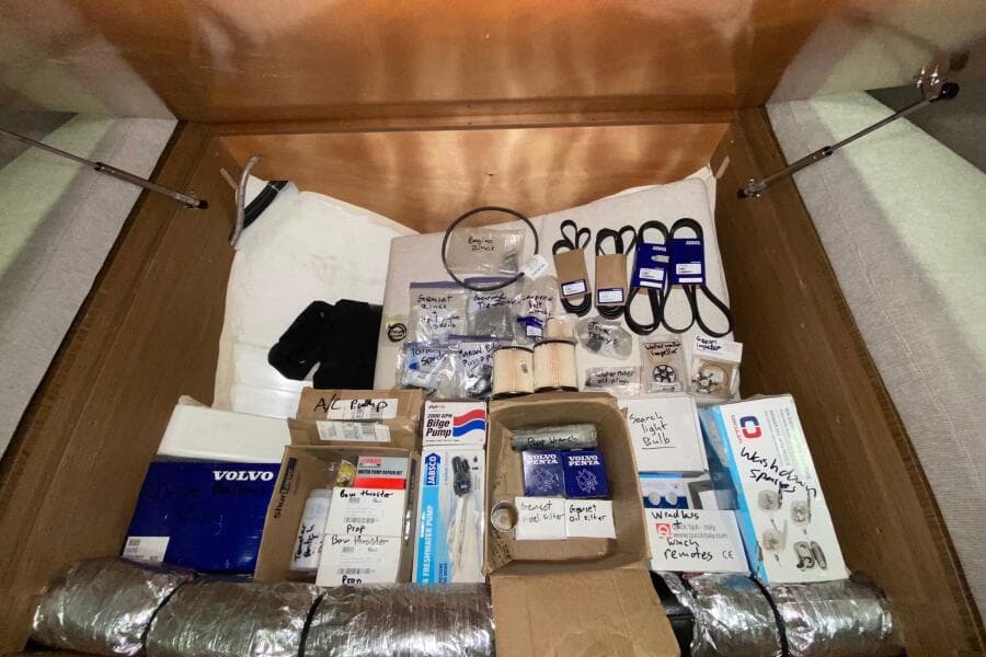 Storage compartment with various spare parts for a 2014 Beneteau Gran Turismo 44 yacht.