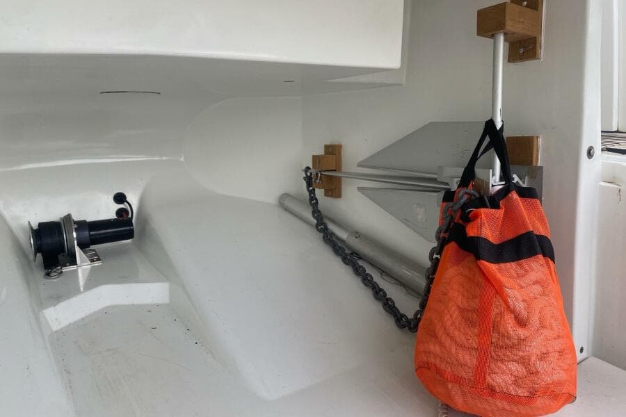 Storage compartment of 2014 Beneteau Gran Turismo 44 with anchor and orange mesh bag.