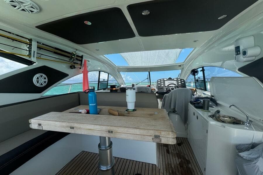 Interior of 2014 Beneteau Gran Turismo 44 yacht with wooden table and modern amenities.