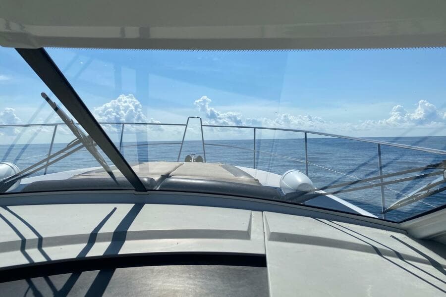 2014 Beneteau Gran Turismo 44 yacht cruising on open sea under clear blue sky.