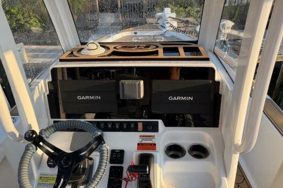 2018 Sea Hunt BX 25 FS boat dashboard with Garmin navigation systems and steering wheel.