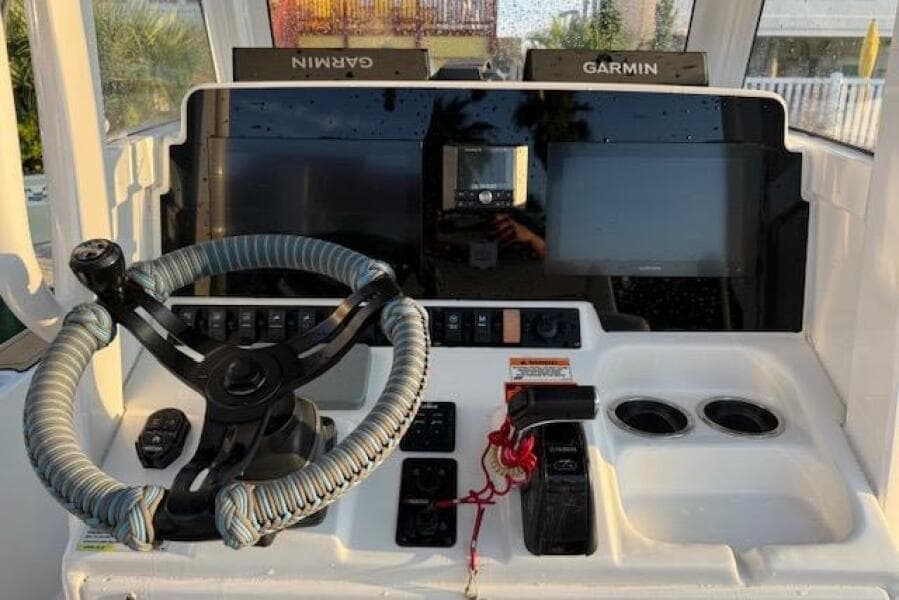 2018 Sea Hunt BX 25 FS boat dashboard with Garmin navigation and wrapped steering wheel.