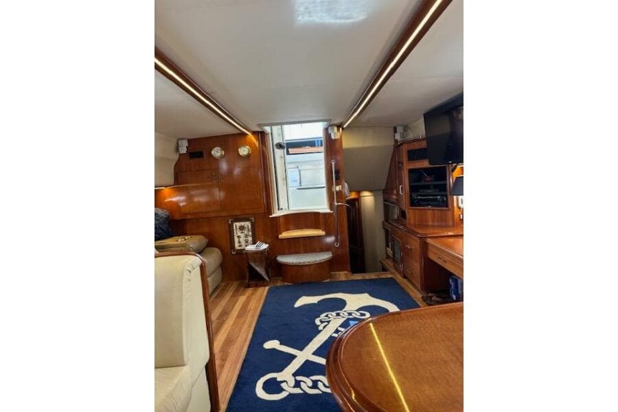 Interior of 2004 Carver 466 Motor Yacht with wood finish and nautical decor.