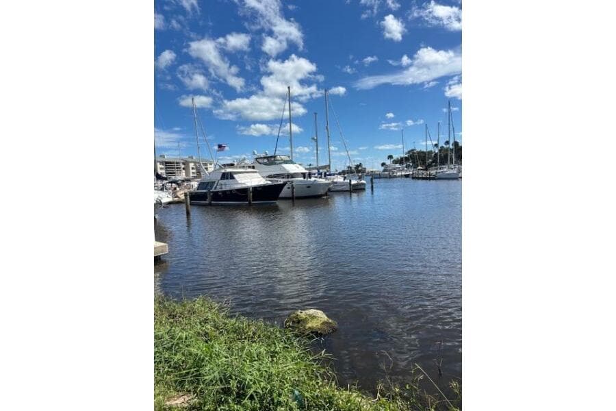 2004 Carver 466 Motor Yacht docked in a sunny marina with blue skies.