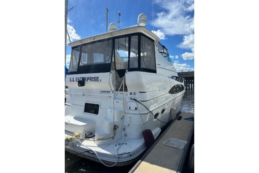 2004 Carver 466 Motor Yacht docked, rear view with clear skies.