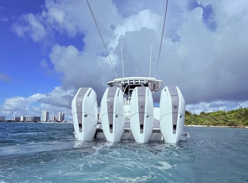 2024 Scout 400 LXF boat with four powerful outboard engines on the water.