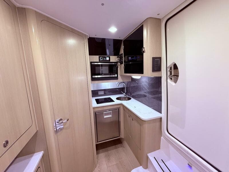 2024 Scout 400 LXF boat interior kitchen with modern appliances and sleek design.