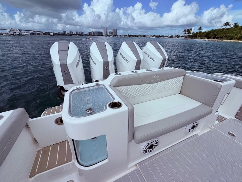 2024 Scout 400 LXF boat with Mercury engines, luxurious seating, and ocean view.