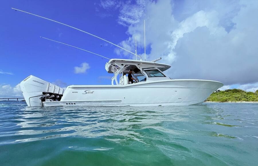 2024 Scout 400 LXF boat on water under clear blue sky.
