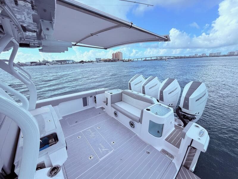 2024 Scout 400 LXF boat with Mercury engines on a calm sea.