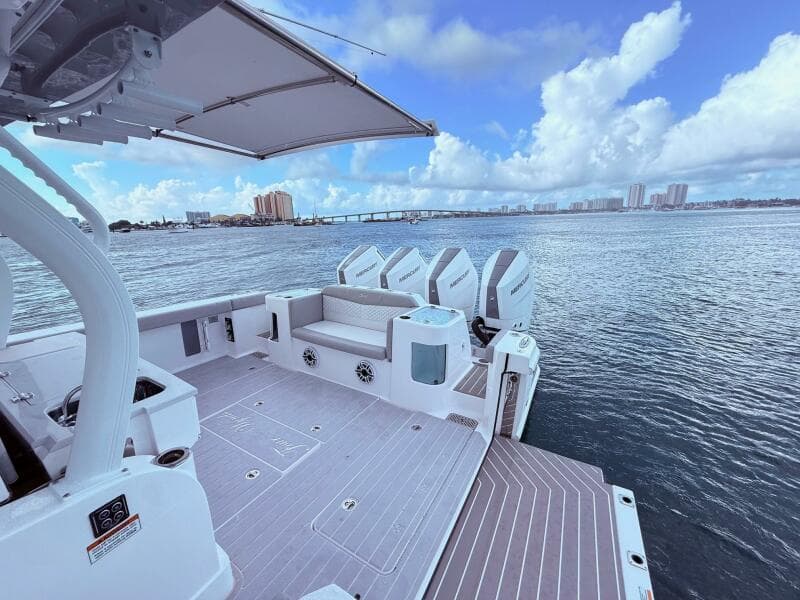 2024 Scout 400 LXF boat with Mercury engines on a calm water backdrop.
