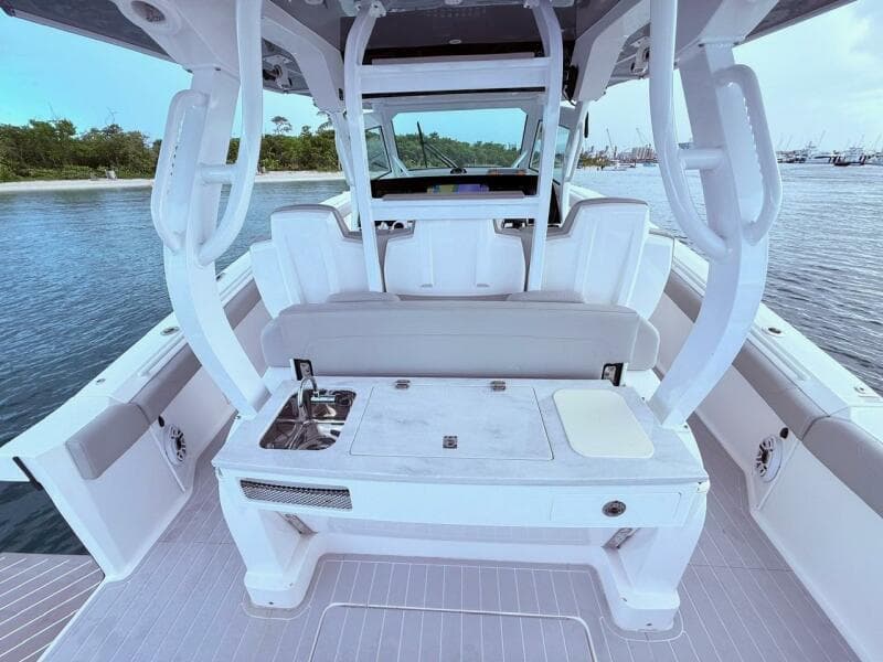 2024 Scout 400 LXF boat interior with seating and sink, docked by the water.