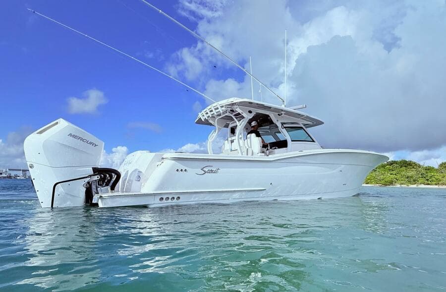 2024 Scout 400 LXF boat on water, featuring sleek design and powerful Mercury engine.