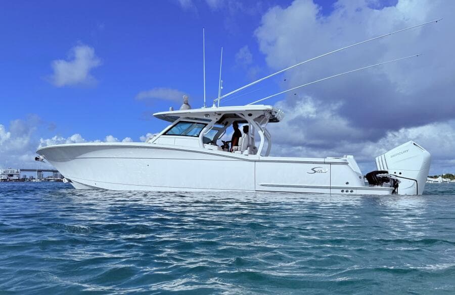 2024 Scout 400 LXF boat on water under blue sky.