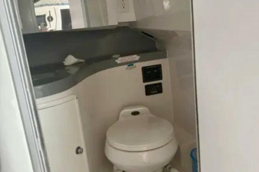 2002 Wellcraft 290 Coastal boat bathroom interior with toilet and counter.