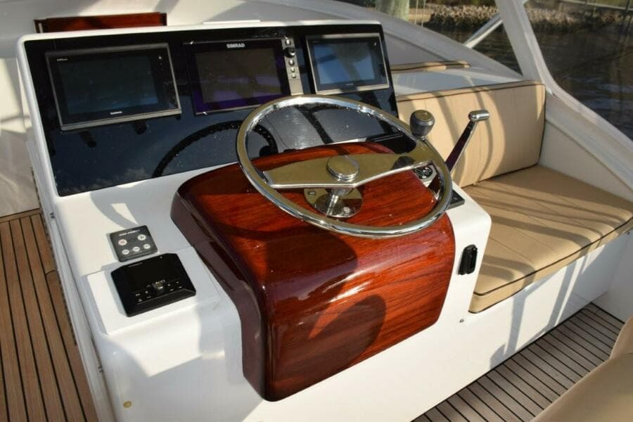 Custom Helm Wheel With Speed Knob, Newer Garmin Displays With A Simrad MFD In Center (displays Engine Gauges).