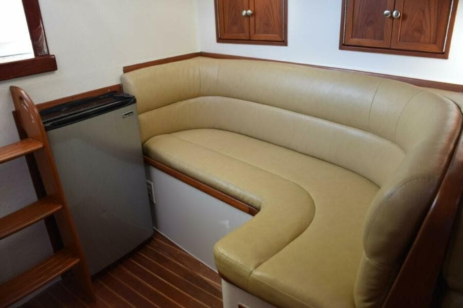 L Shape Settee And Refrigerator. Small Cabinet Storage Above