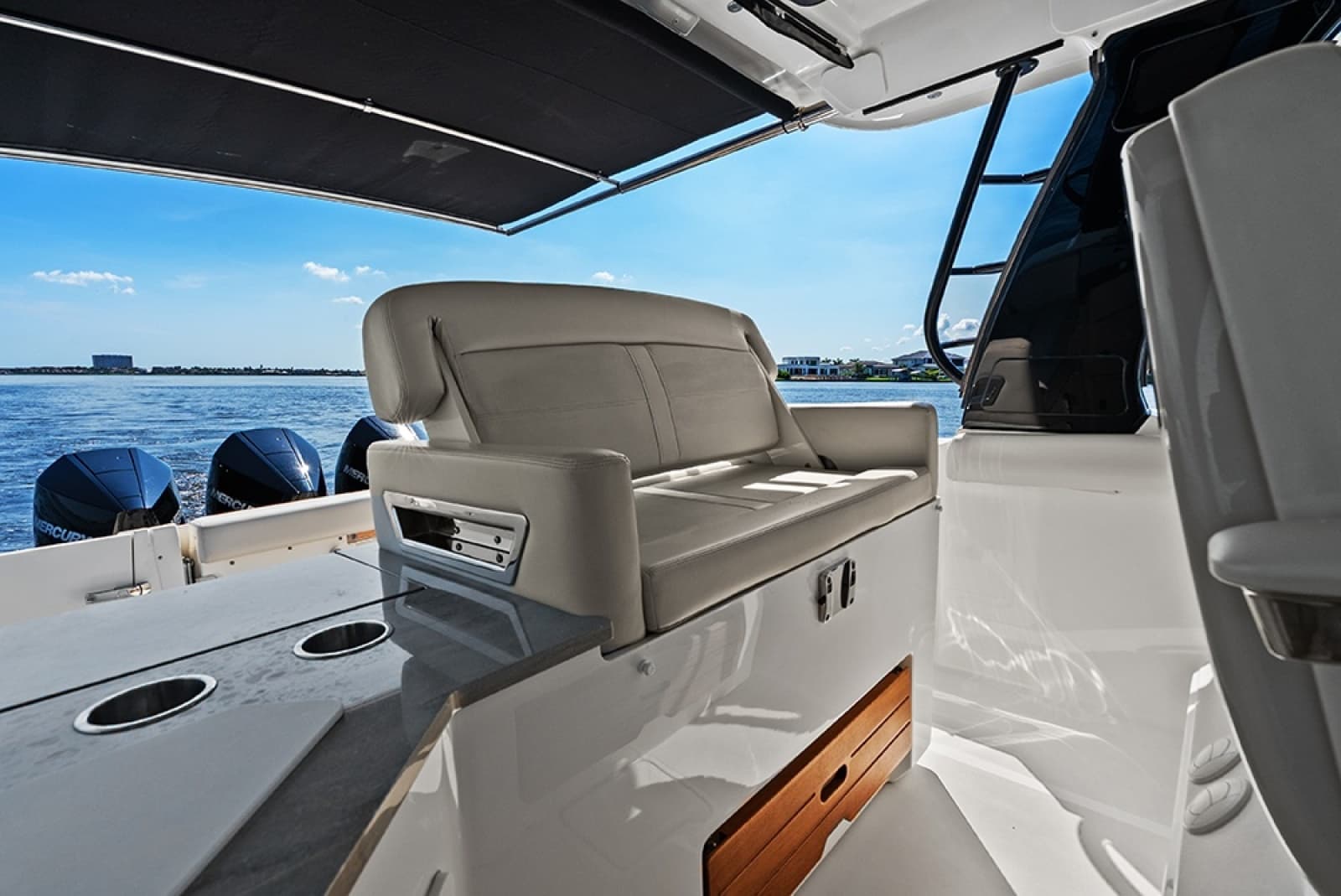 Helm deck second row seat with a conversation seatback