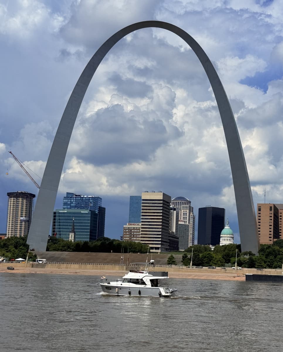 Beneteau Swift Trawler 35 cruising near arch and city skyline