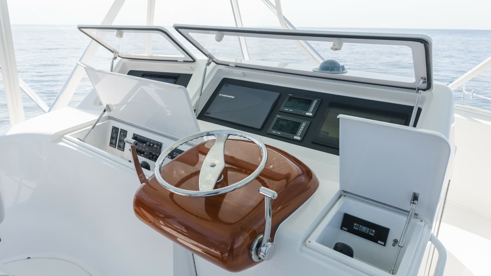 2009 Viking 50 Convertible " Jammin" - A Polished Stainless Steel Steering Wheel, Complemented by a Beautifully Finished Wood Helm Base and a Crisp White Helm Station, Creates a Refined and Timeless Command Center.