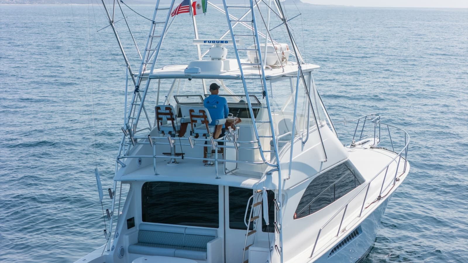 2009 Viking 50 Convertible "Jammin" - Aft View Showcasing the Elevated Flybridge Helm Station and the Yacht's Spacious, Open-Air Design.