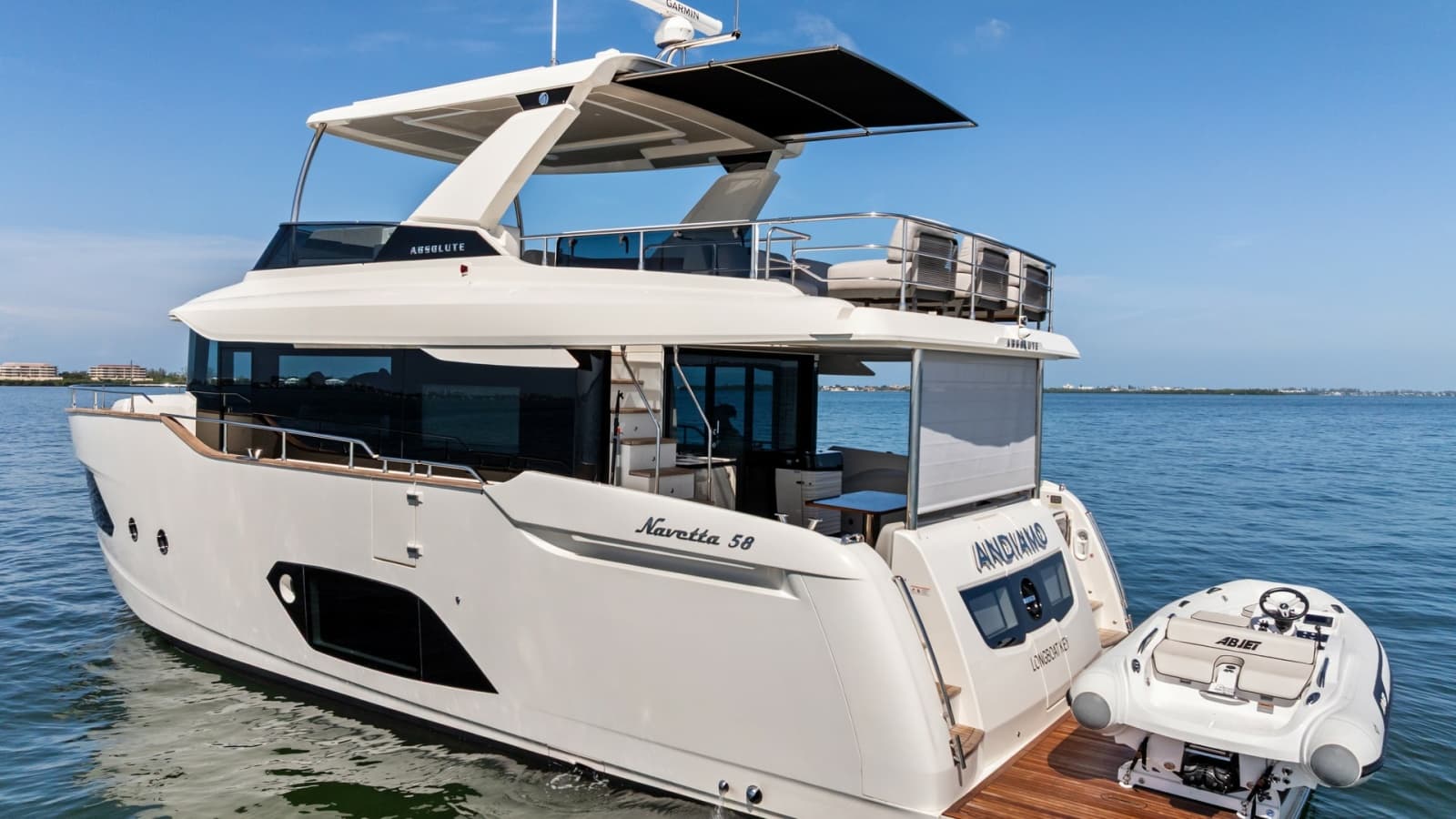 2026 Absolute Navetta 58 "ANDIAMO" Showcases a Sleek Design with a Convenient Tender Storage Platform. The Spacious Area Includes a Teak-Finished Deck, Providing an Elegant Touch and Easy Access to the Water.