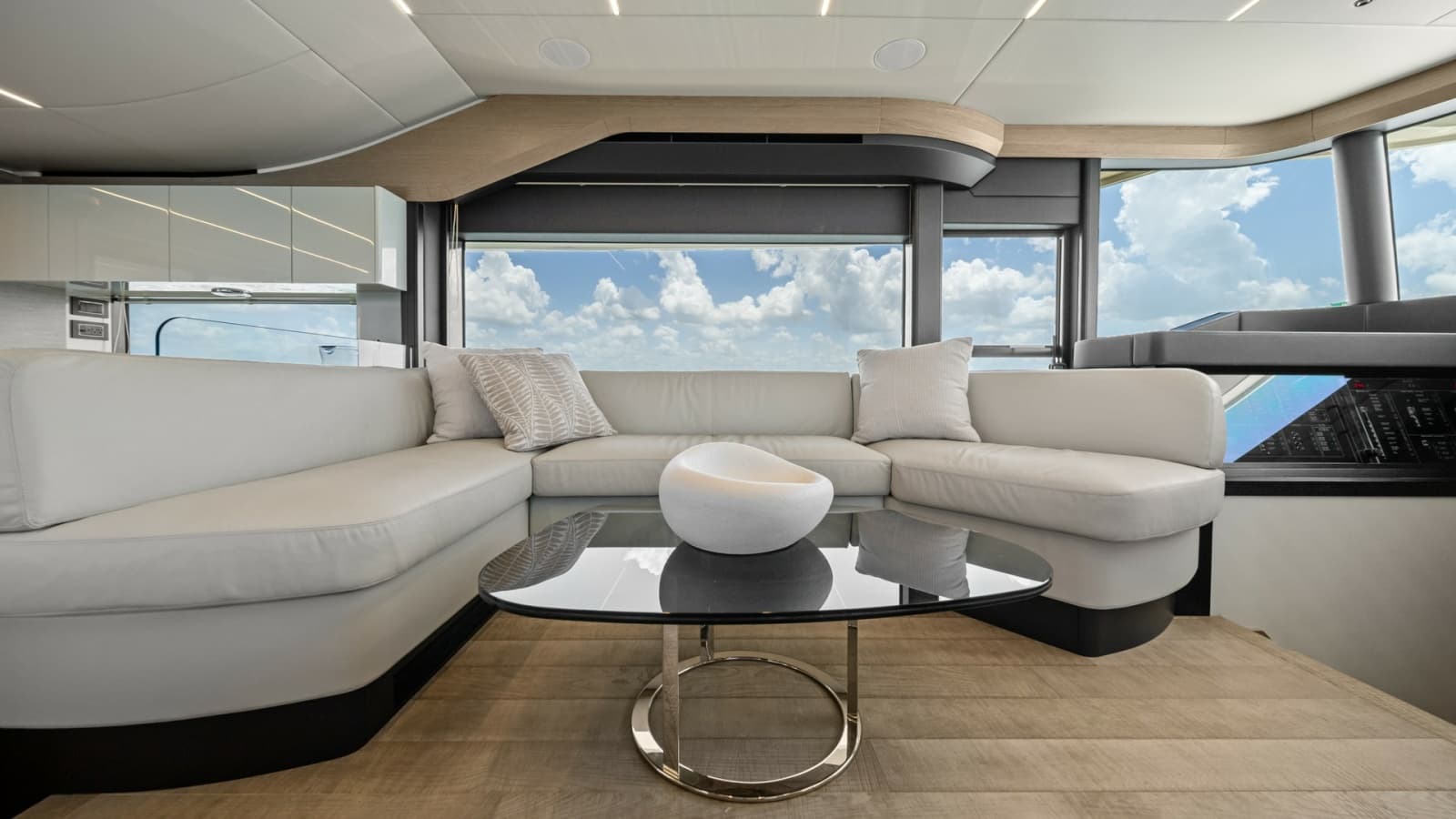 2026 Absolute Navetta 58 "ANDIAMO" - Luxurious and Inviting Space with a Modern L-Shaped Sofa and Sleek Glass Coffee Table.